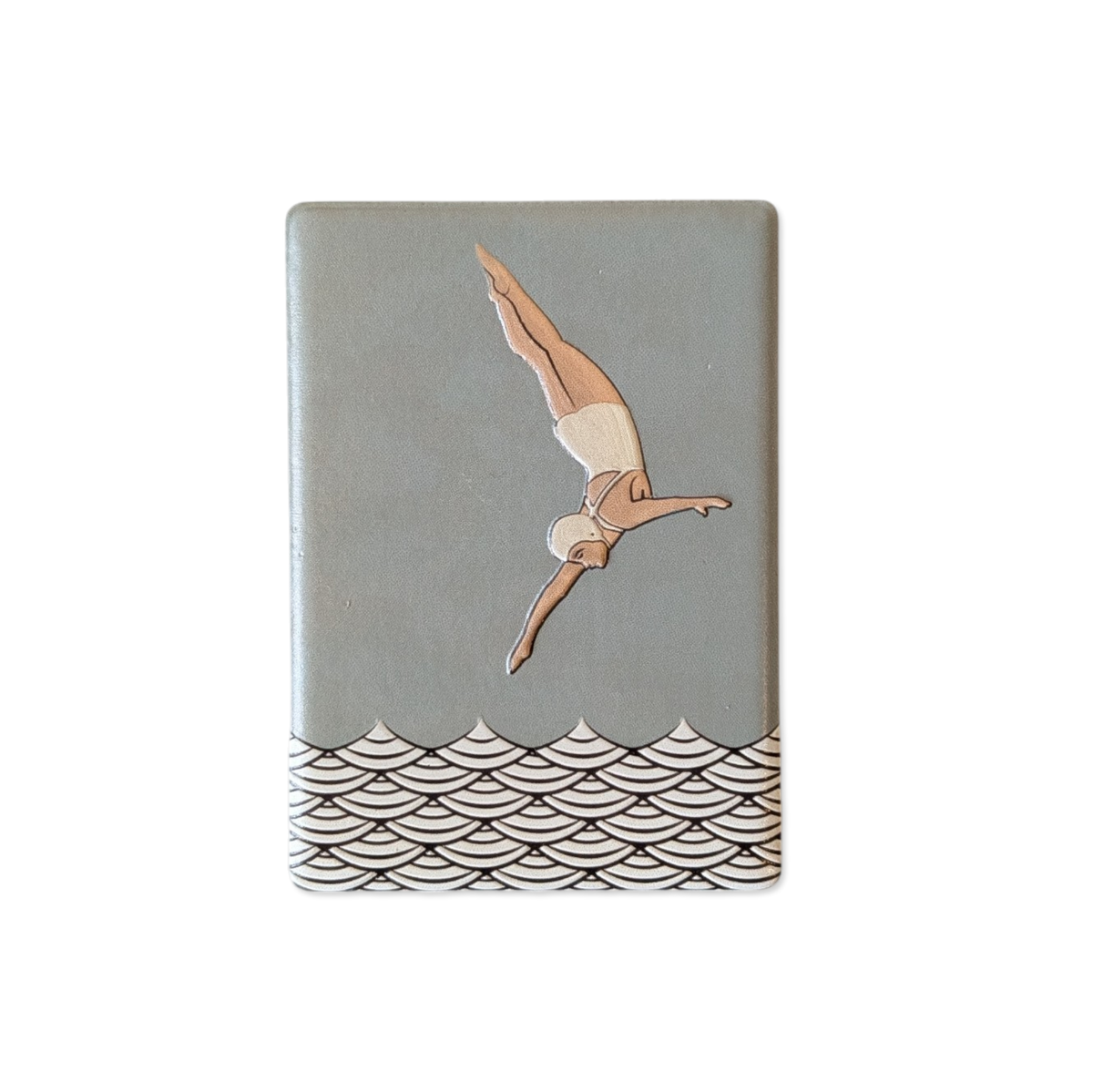 Rechteckiger Keramik-Kühlschrankmagnet (7x5 cm) mit seidenmatter Glasur in Salbeigrün. Zu sehen ist eine Turmspringerin im Art-Déco-Stil im Sprung über einem schwarz-weißen Wellenmuster im fühlbaren 3D-Relief.