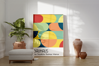 Dieses Bauhaus Poster zeigt dir verschiedene geometrische Formen die bunt dargestellt sind. Das in schönem Blau- und Rottönen gehaltene Poster hat die Bildunterschrift Das Staatliche Bauhaus